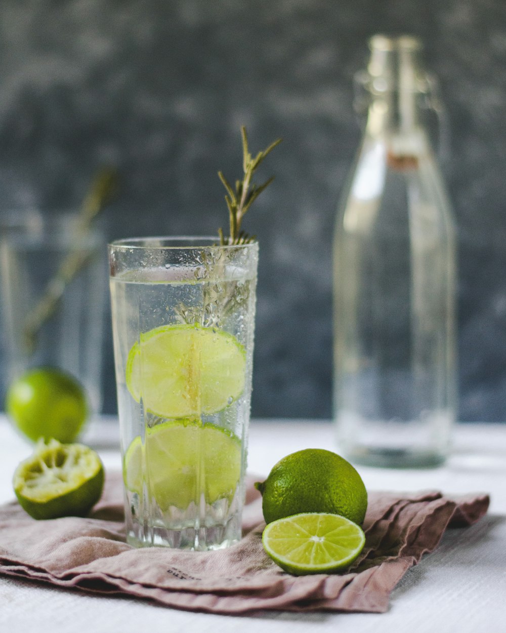sliced lemons beside drinking glass