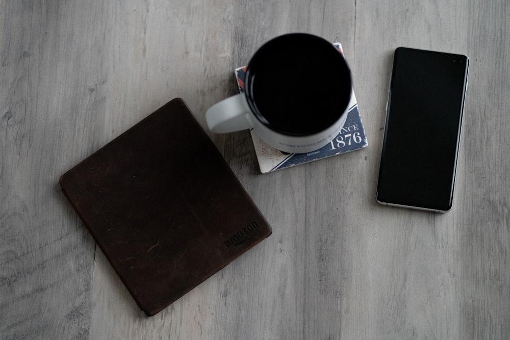 mug, wallet, and smartphone