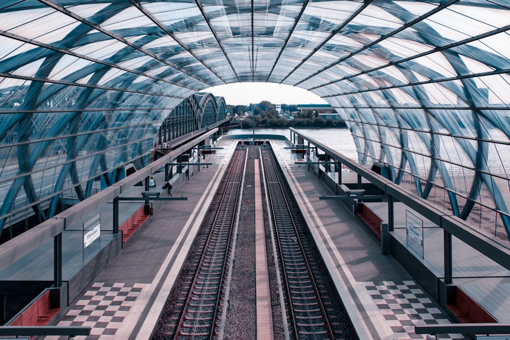 view of train line under glass roof