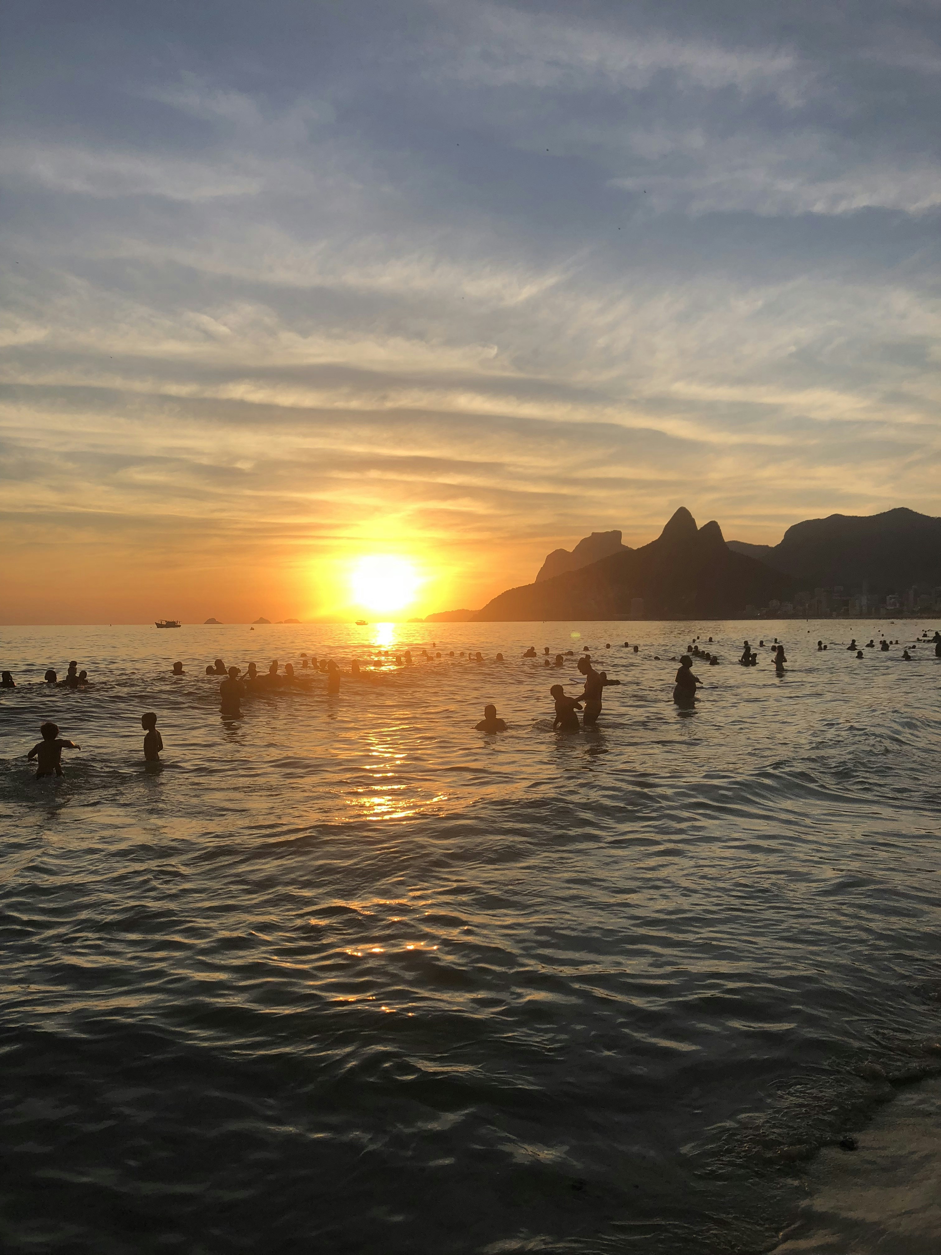 people in sea during sunset