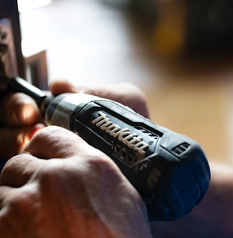 selective focus photography blue and black Makita power drill