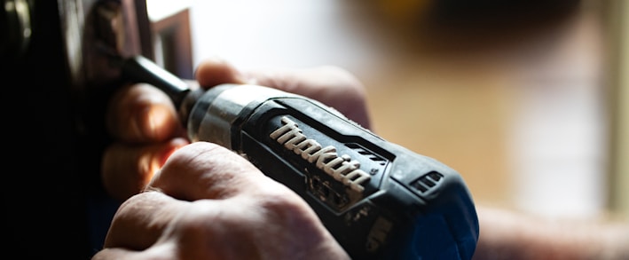 selective focus photography blue and black Makita power drill