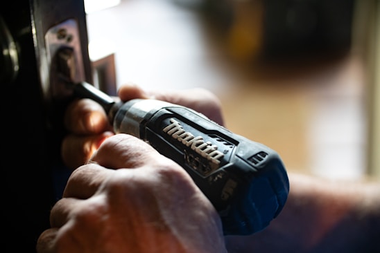 selective focus photography blue and black Makita power drill