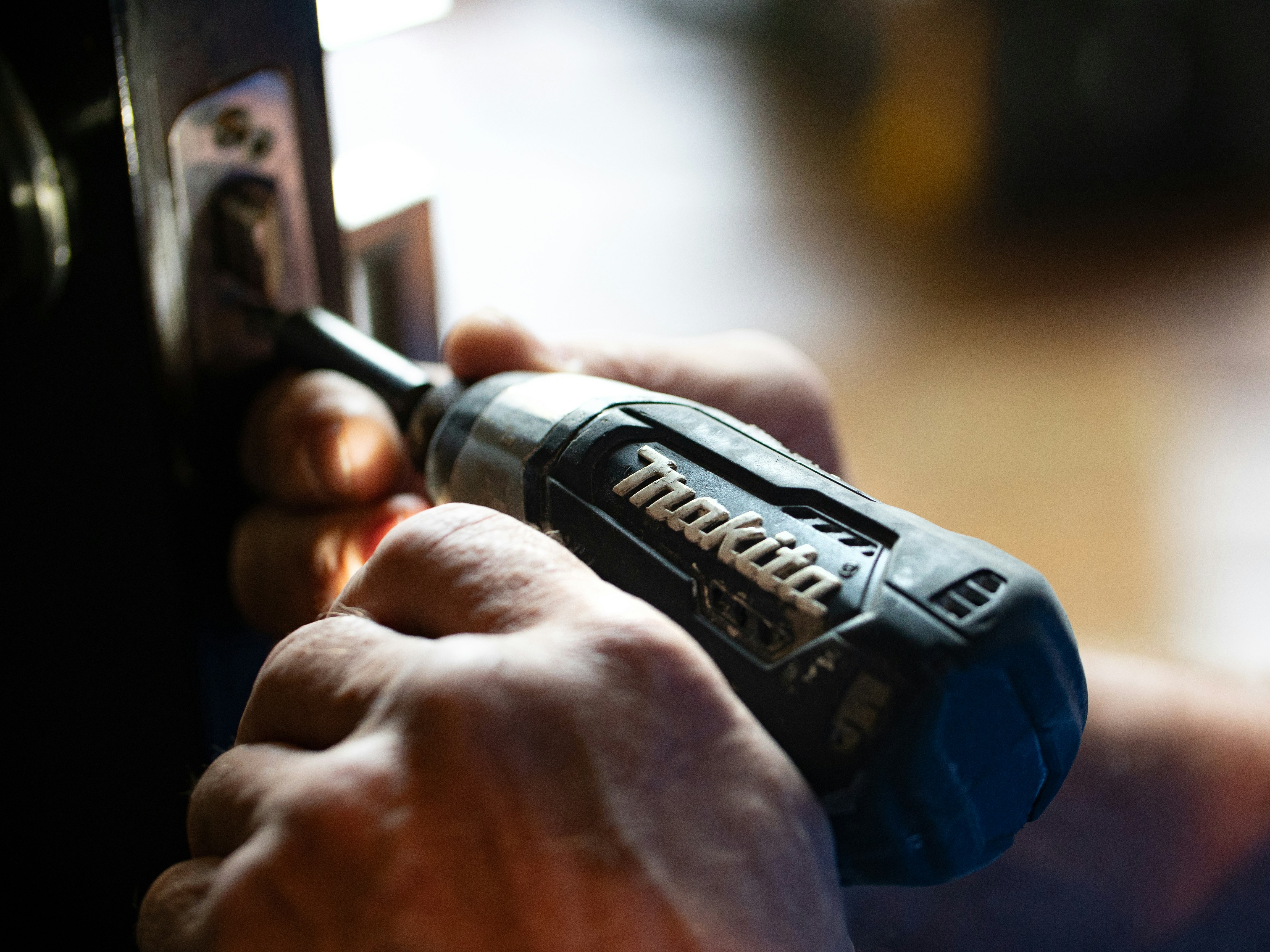 selective focus photography blue and black Makita power drill