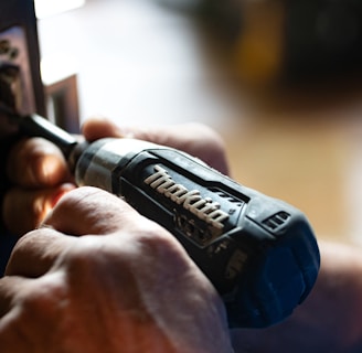 selective focus photography blue and black Makita power drill