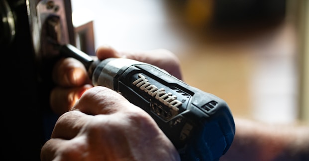 selective focus photography blue and black Makita power drill