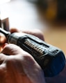 selective focus photography blue and black Makita power drill