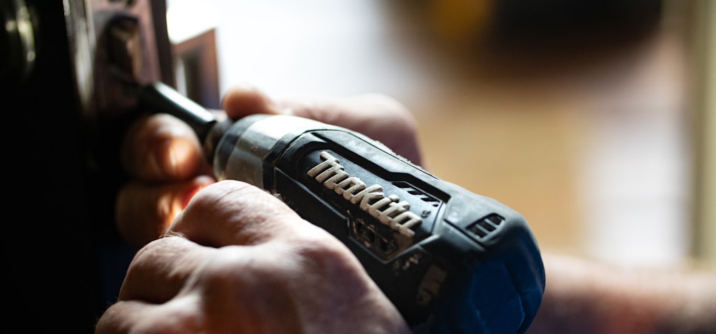 selective focus photography blue and black Makita power drill