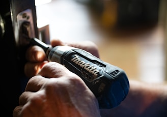 selective focus photography blue and black Makita power drill