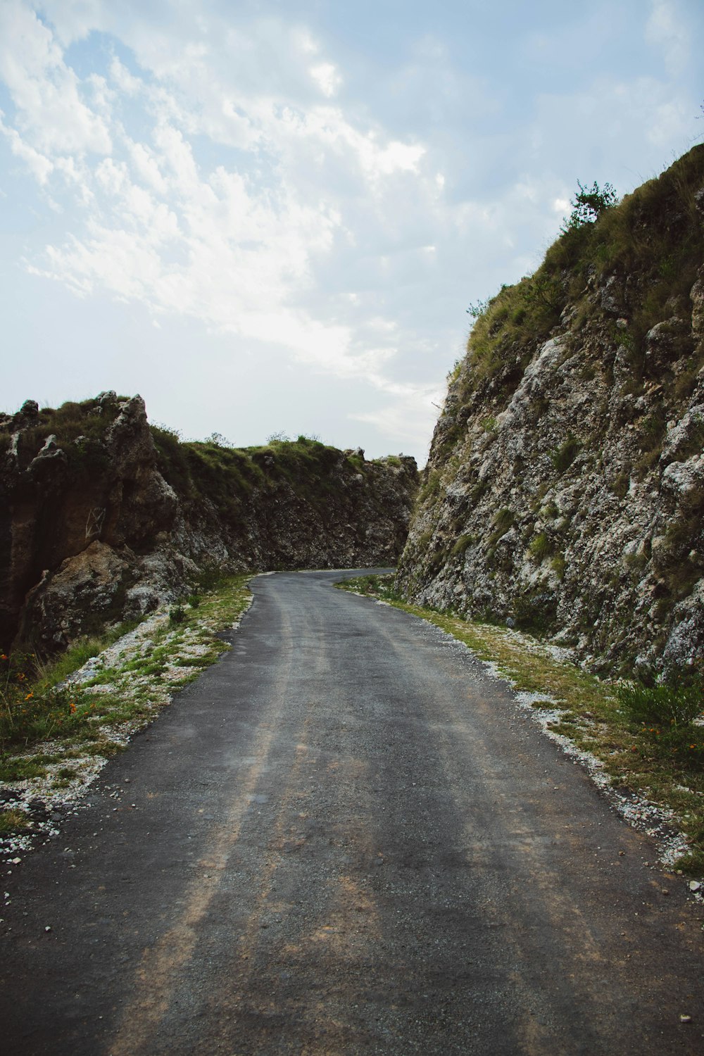 road between hills during daytime