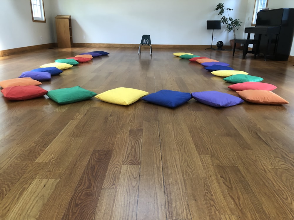 assorted-color throw pillows on the floor