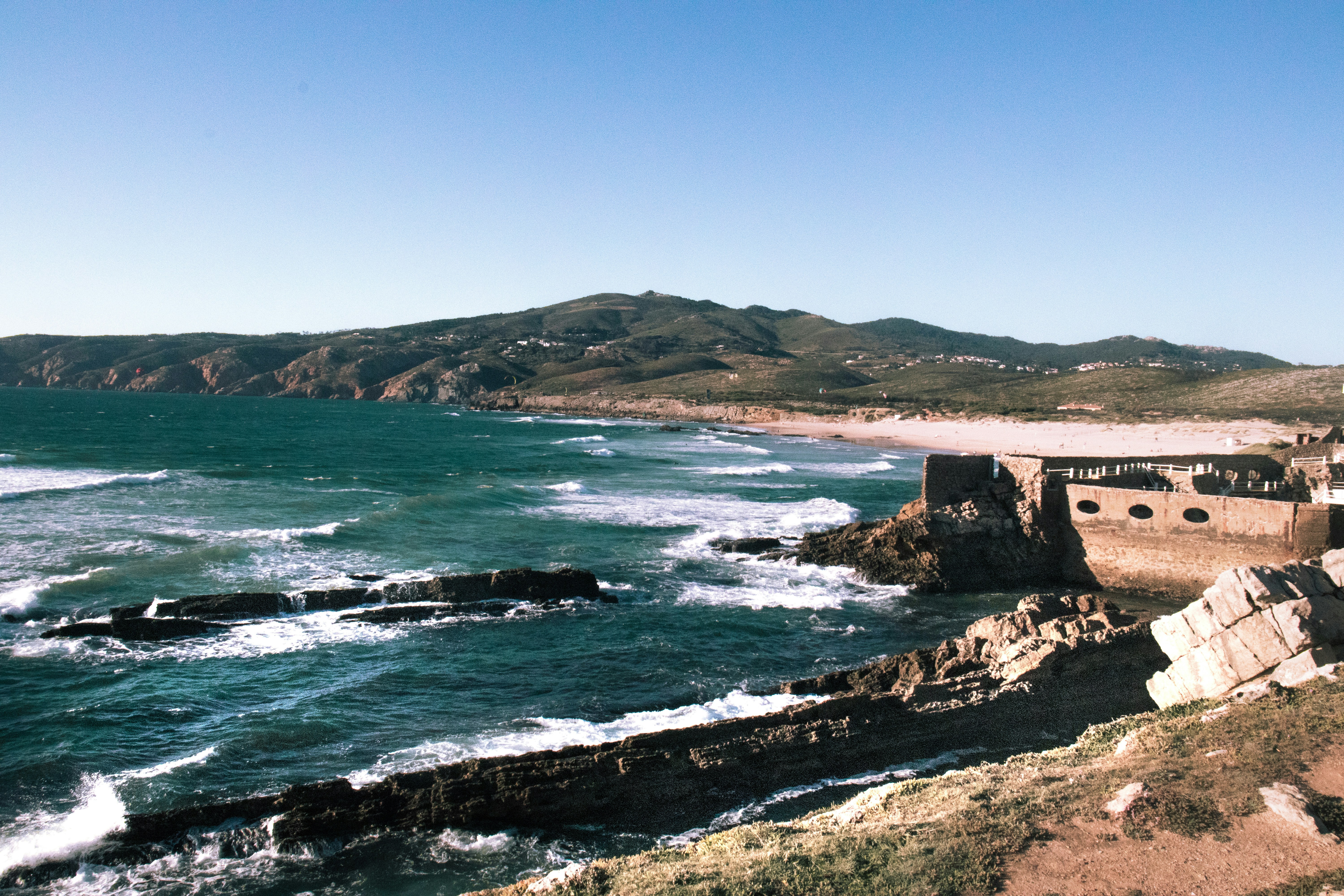 photography of ruin building beside seashore during daytime