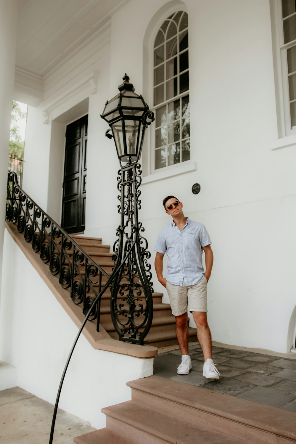 man standing beside wall