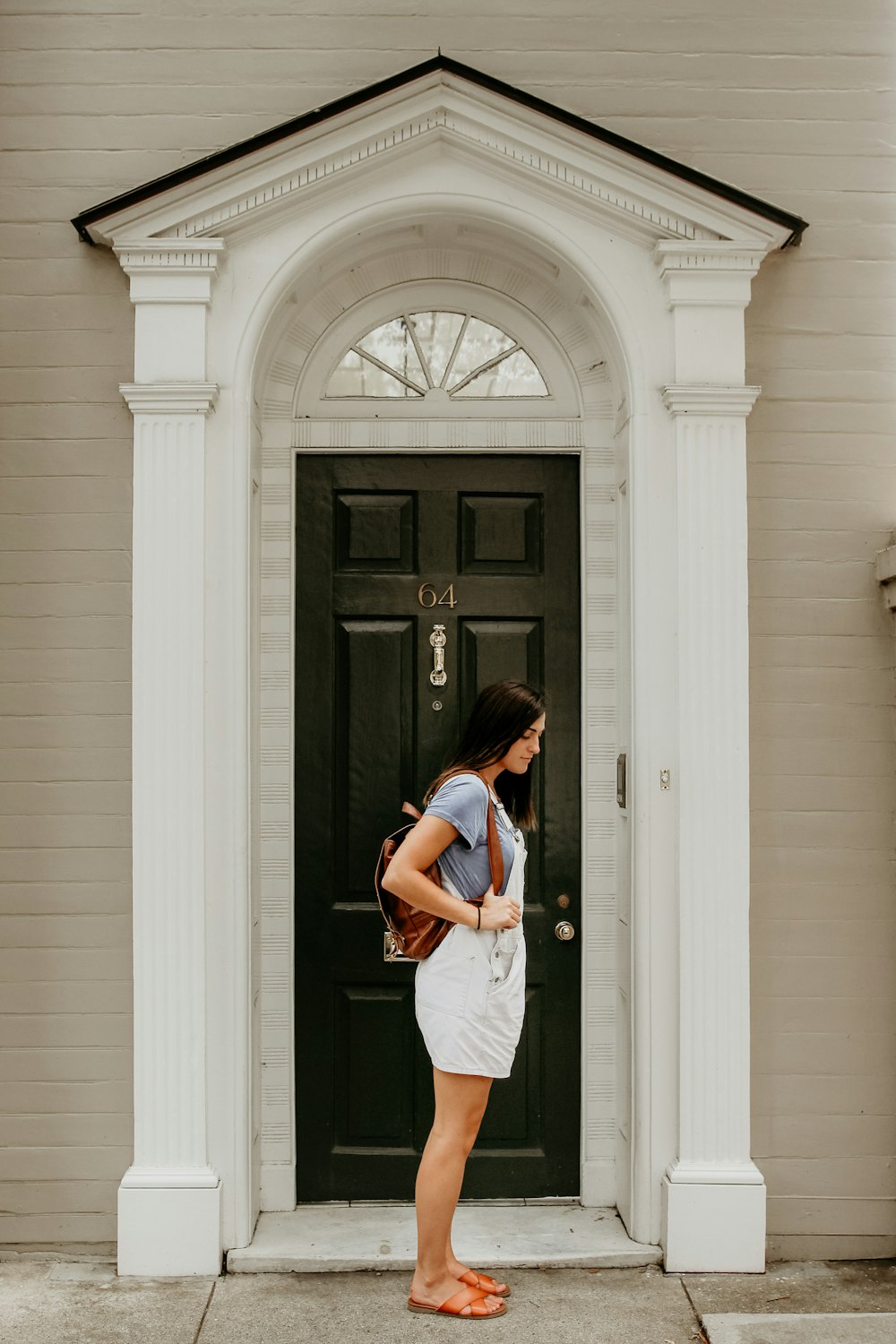 woman standing beside door