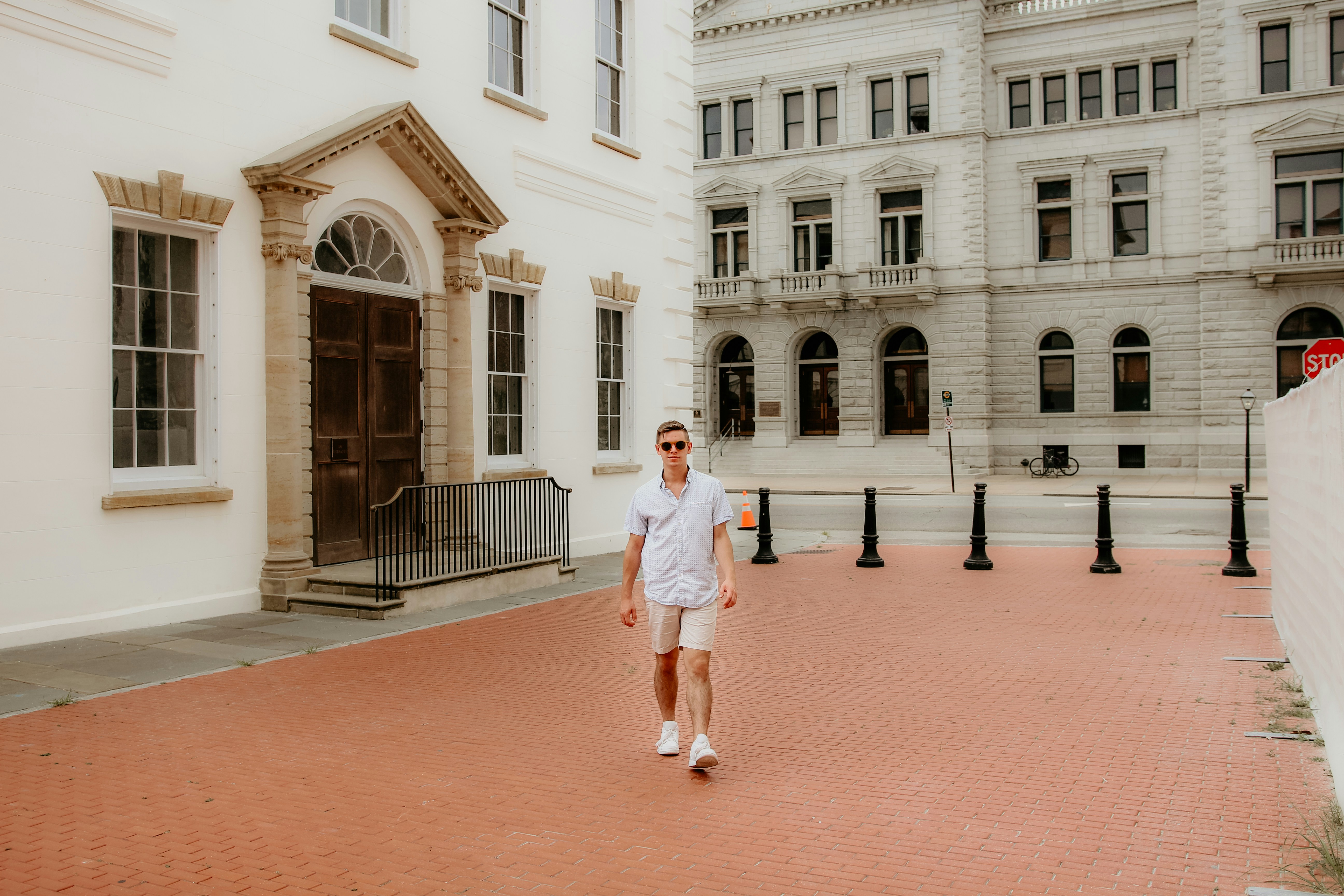 man standing beside buildings