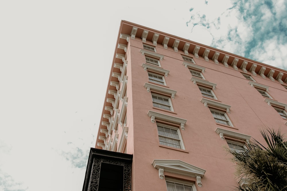 brown concrete building under white clouds