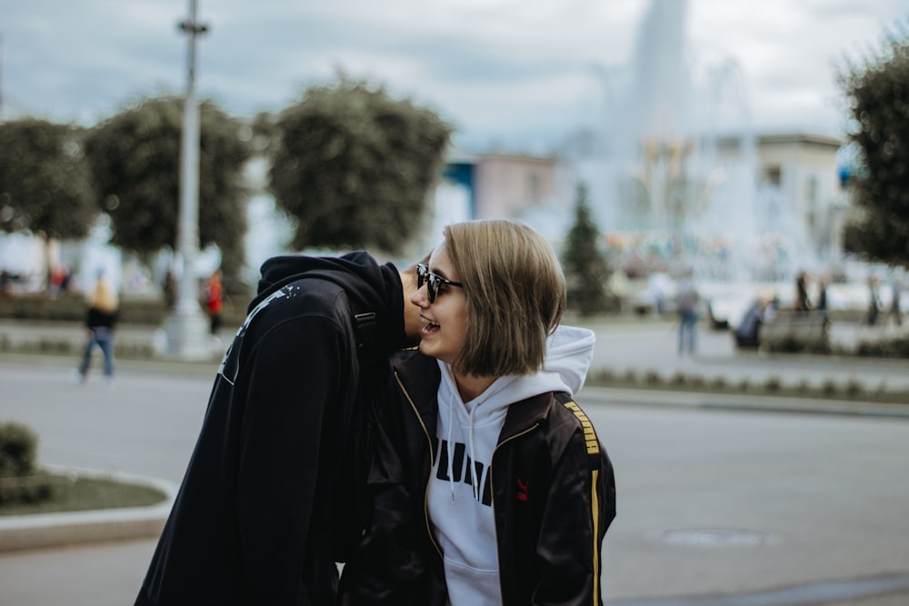 man leaning on woman's shoulder