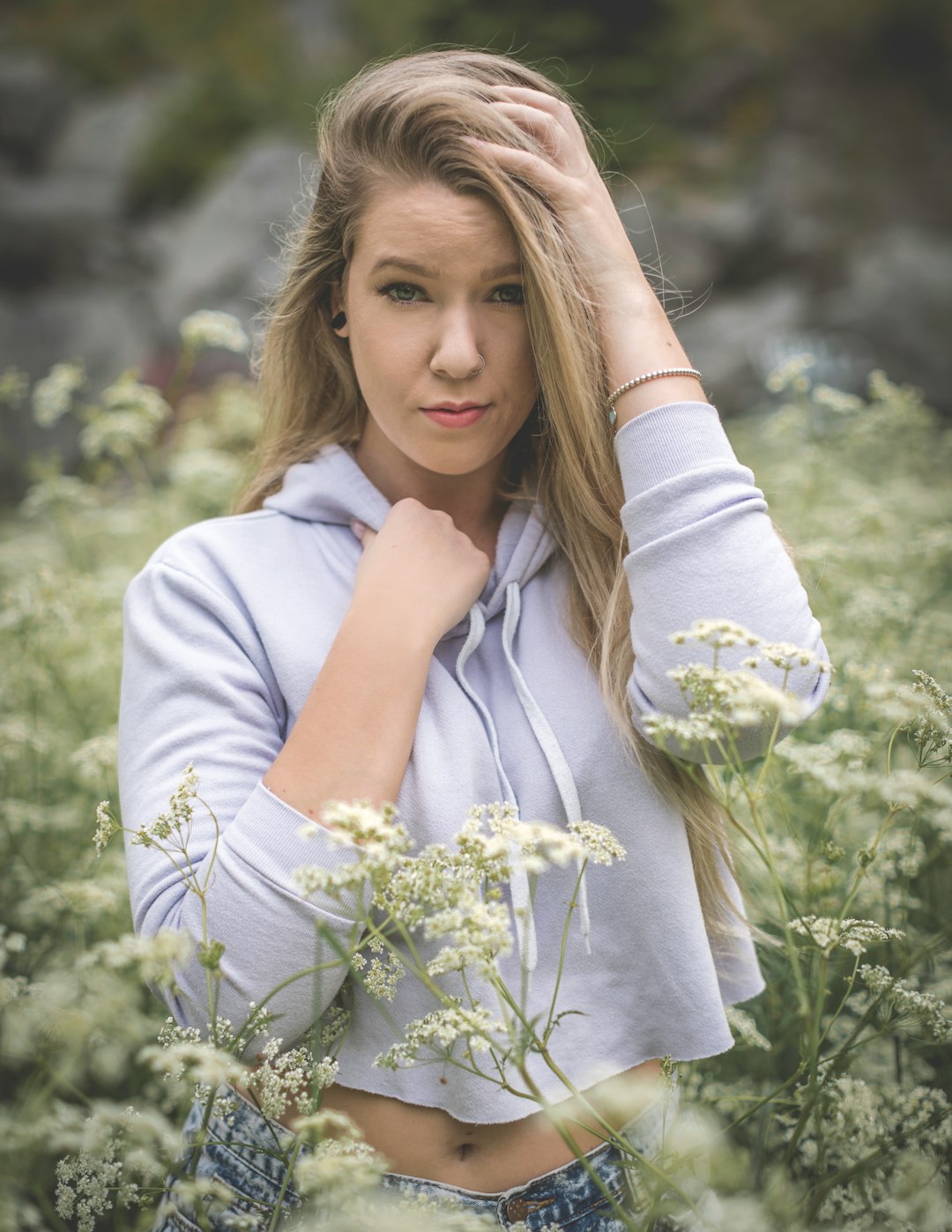 woman standing beside flowers