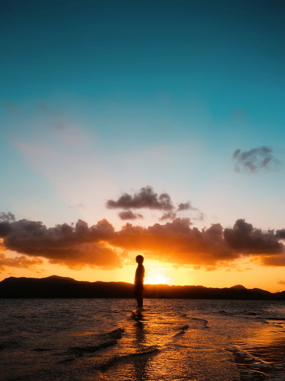 man's silhouette at sunset