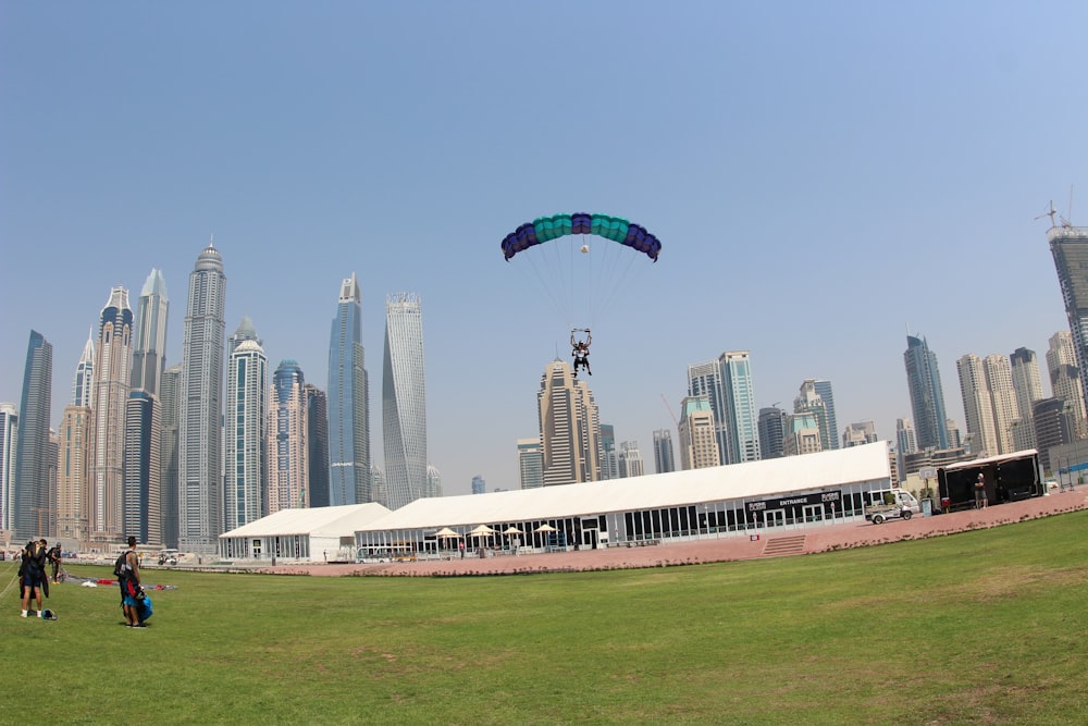 person paragliding near buildings