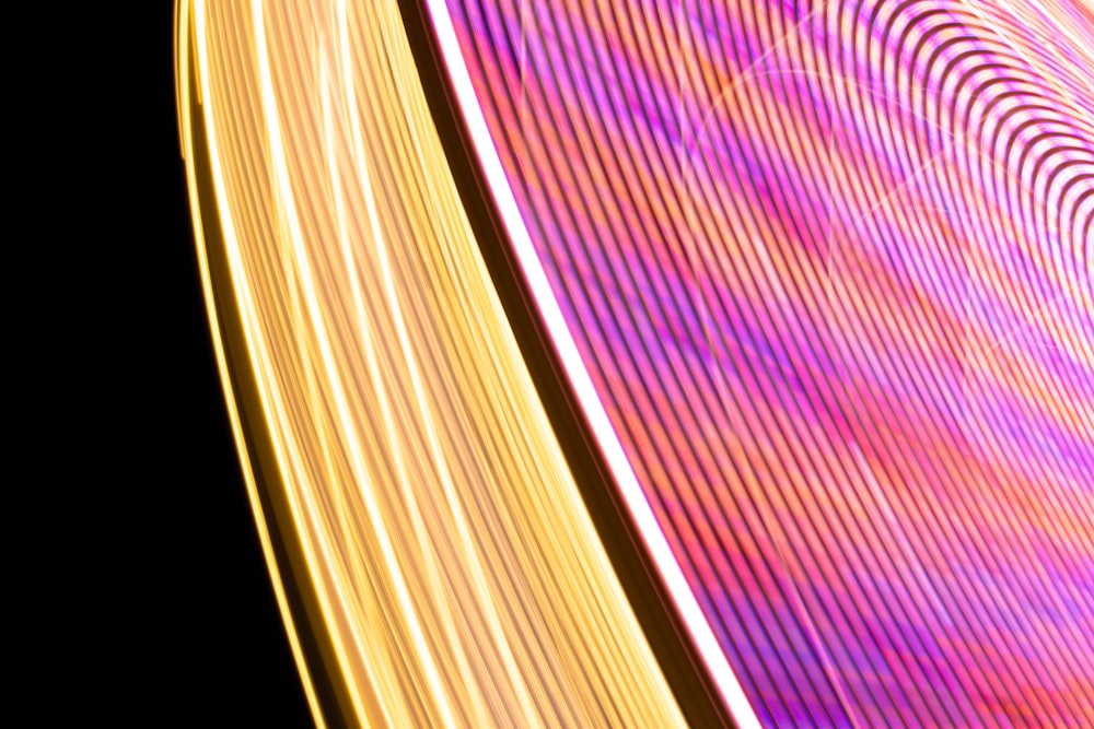 a close up of a ferris wheel at night