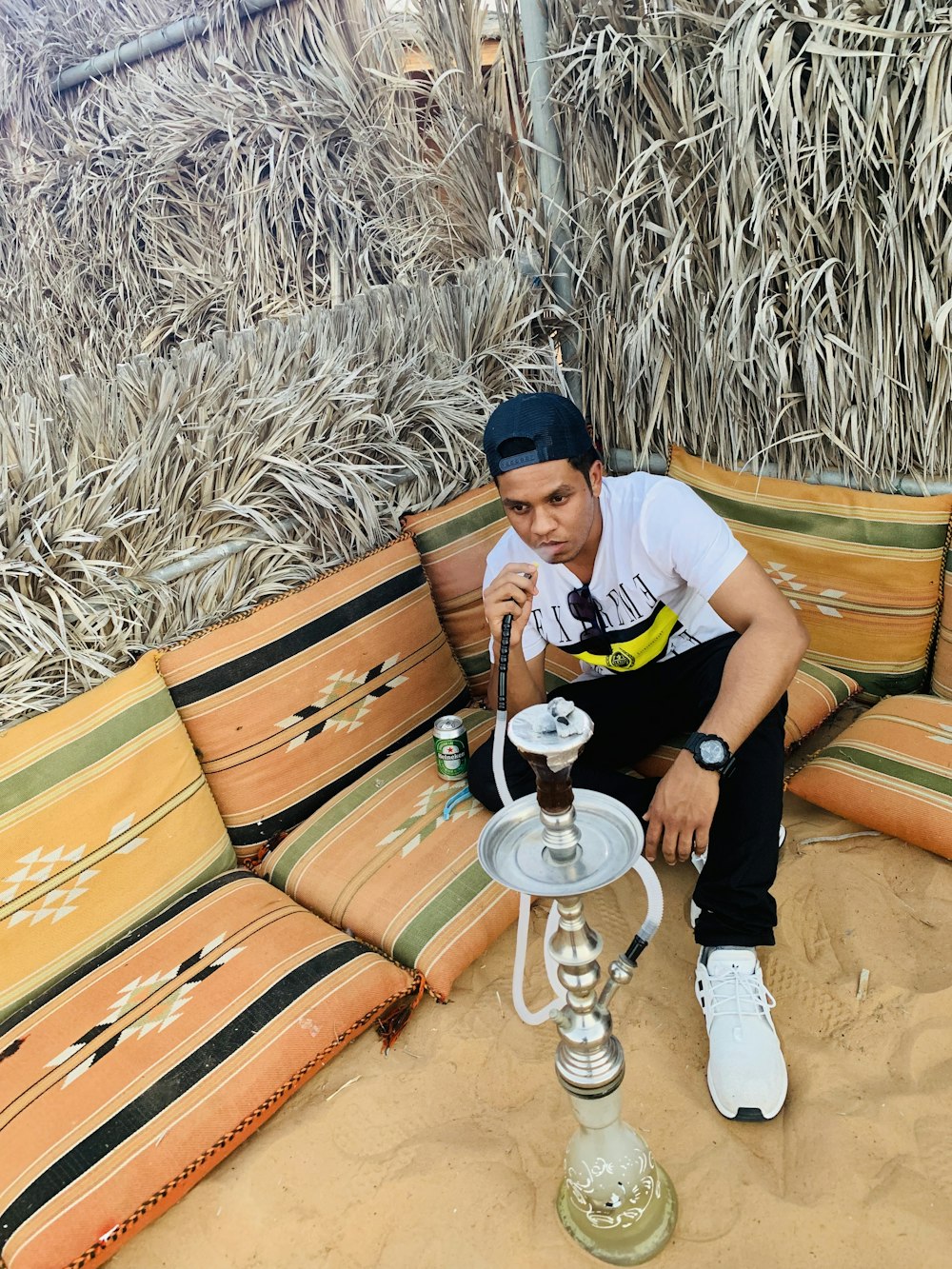 man sitting in front of hookah