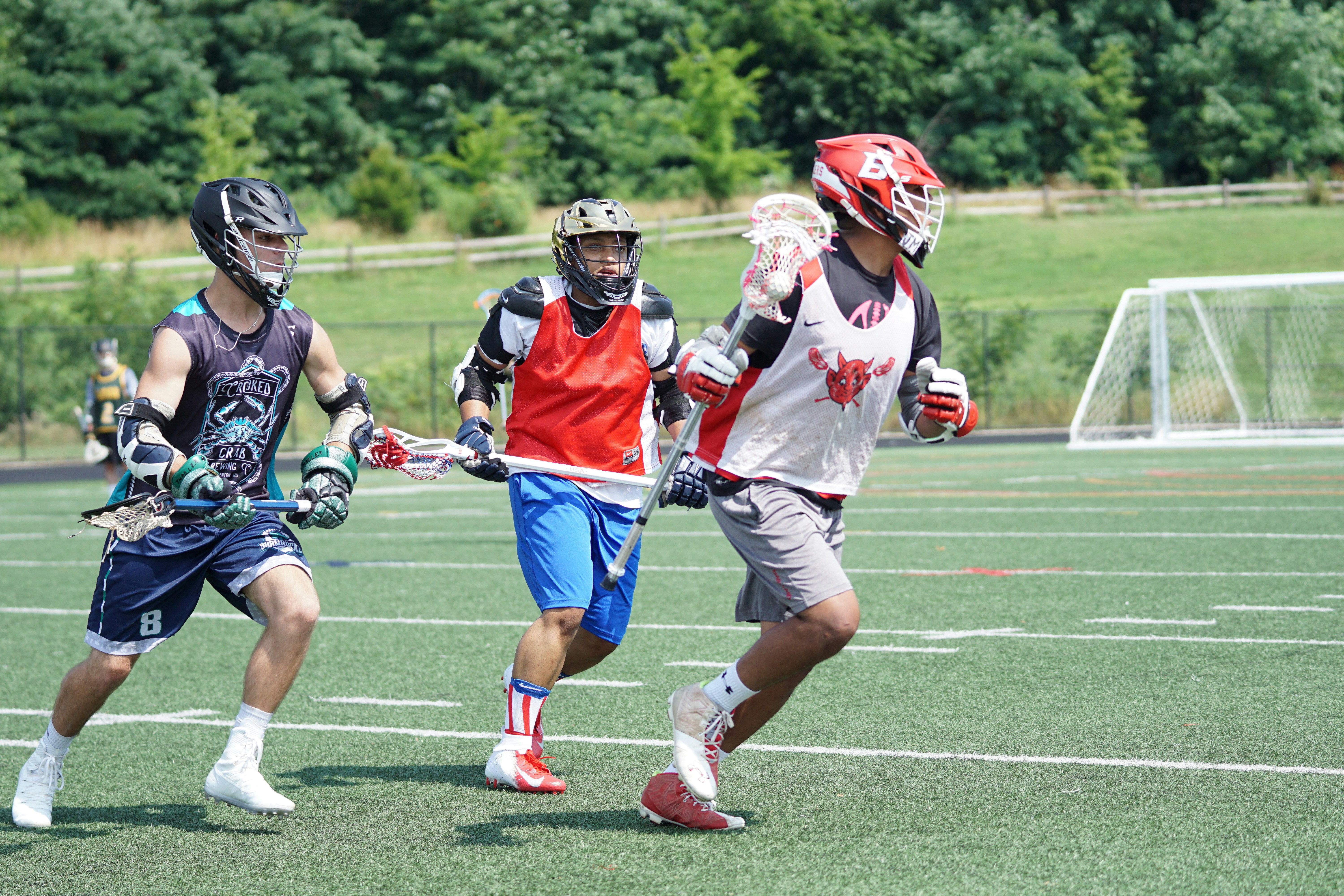three person running on field