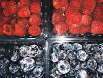 Close-up of frozen fruit packs neatly arranged, highlighting vibrant colors and premium packaging.