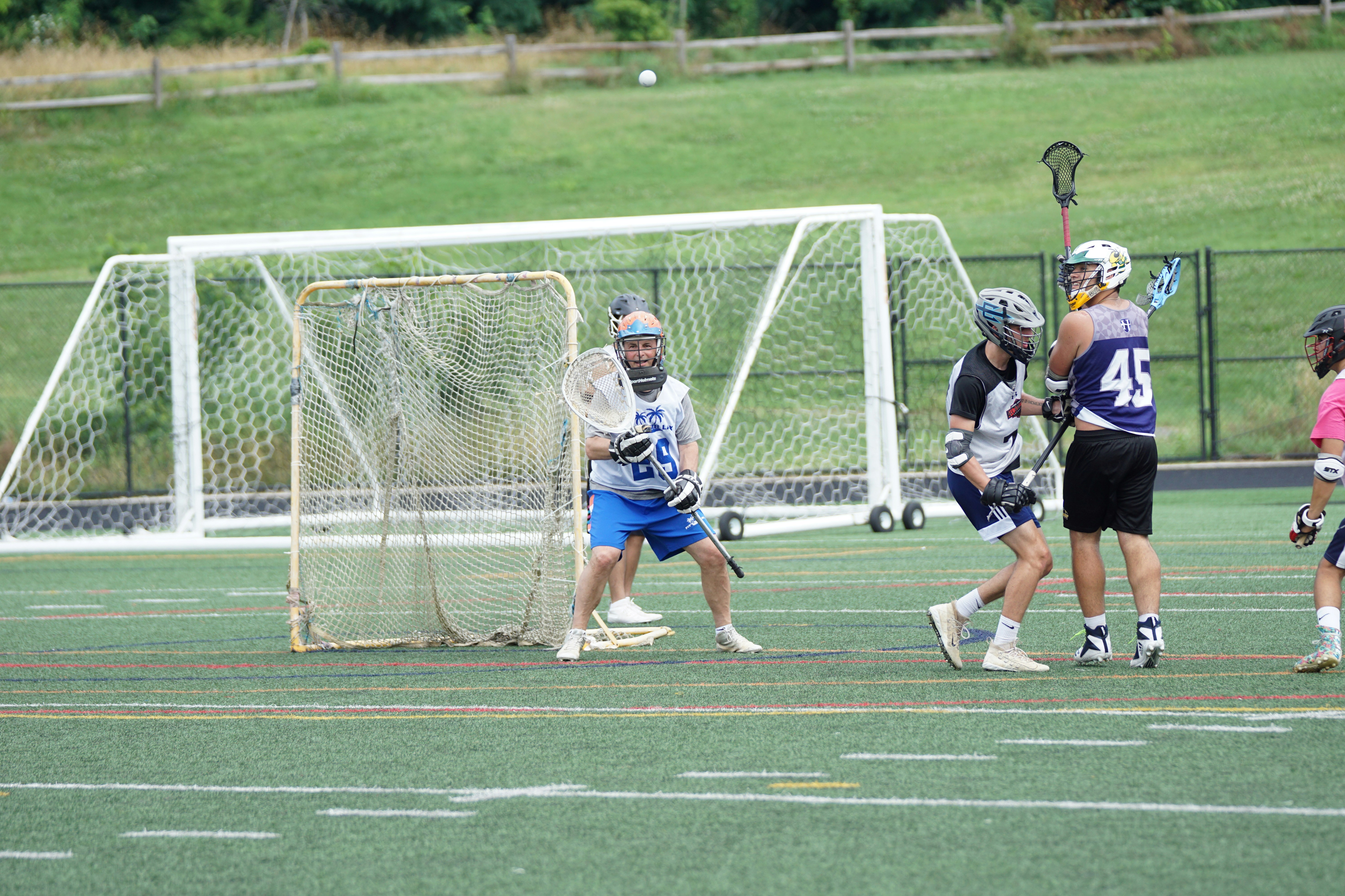 people playing lacrosse during daytime