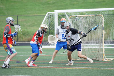 four men playing lacrosse