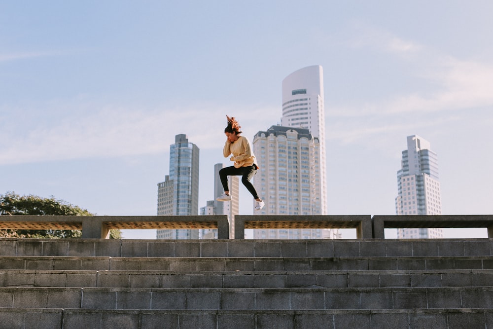 woman jumps from the bench during daytime