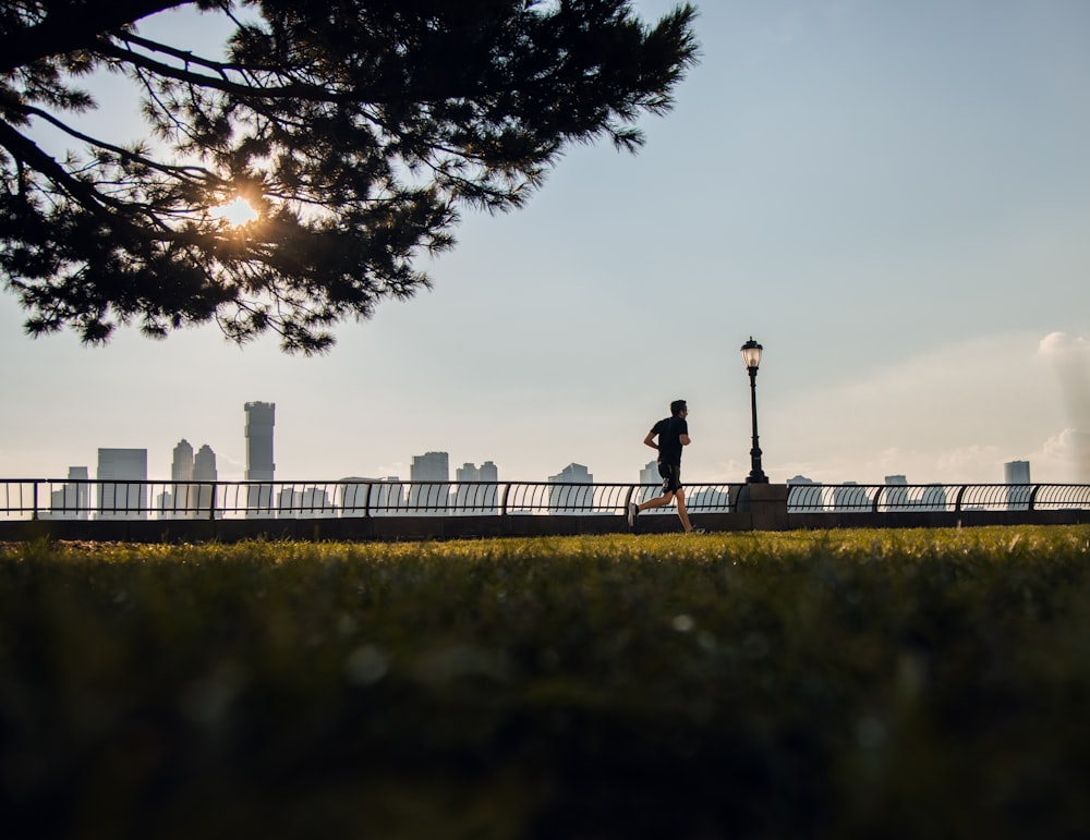 man running along grass field