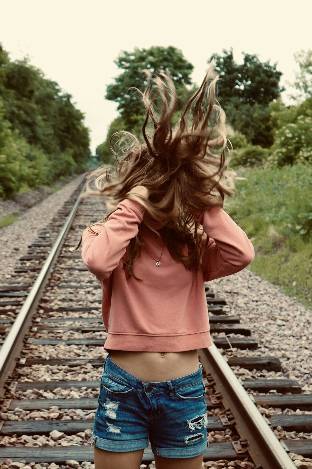 woman wearing sweater and blue denim shorts