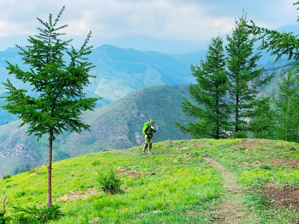 mountaineer walking on trail at mountain top