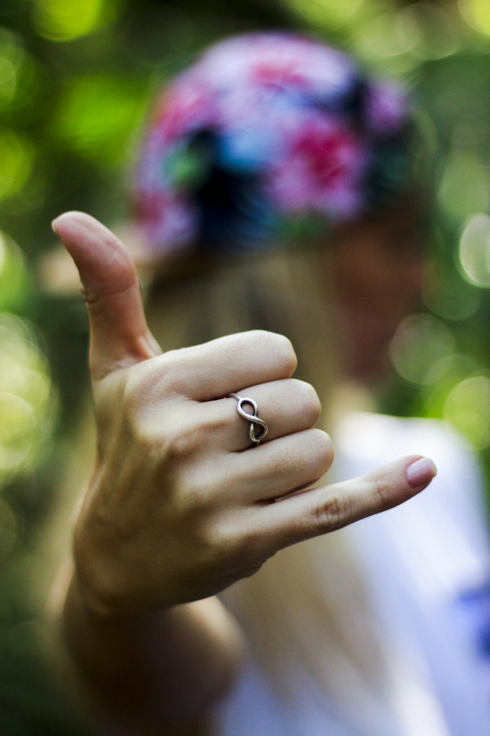 person making rock and roll hand sign