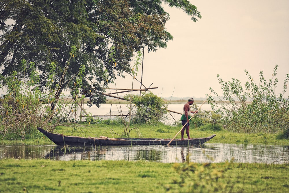 man standing on boat