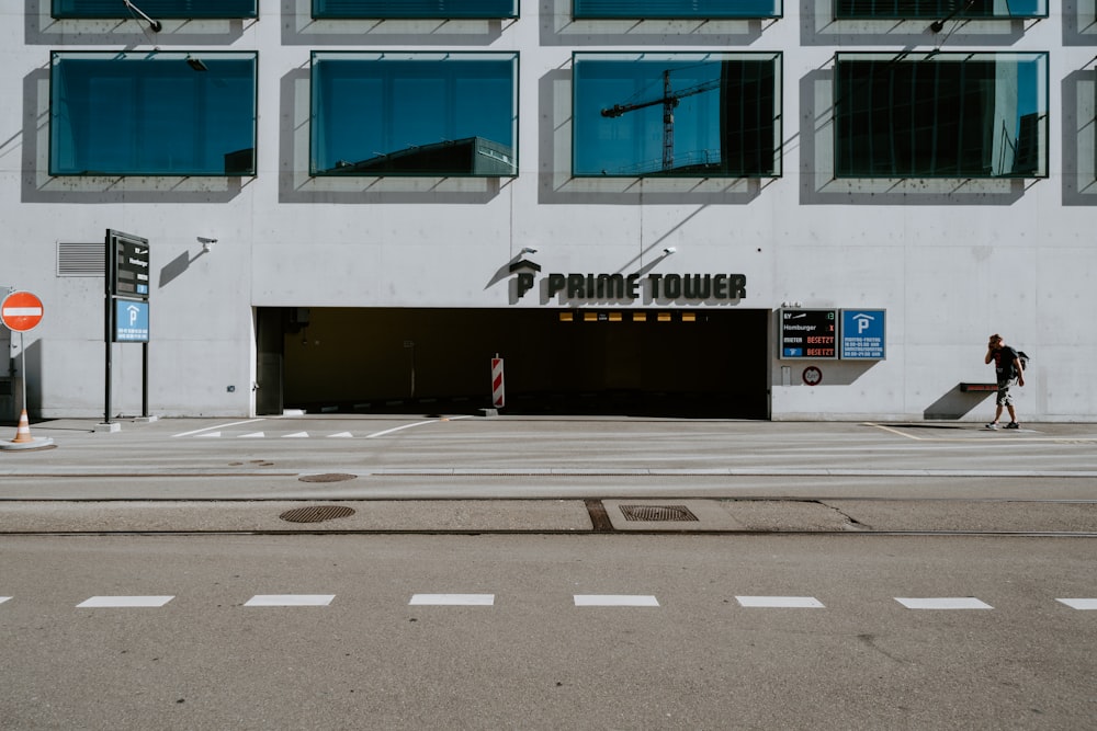 person walking in a road near building during daytime