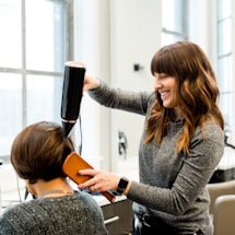 woman holding hair dryer