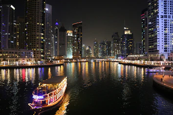 white touring boat sailing during night