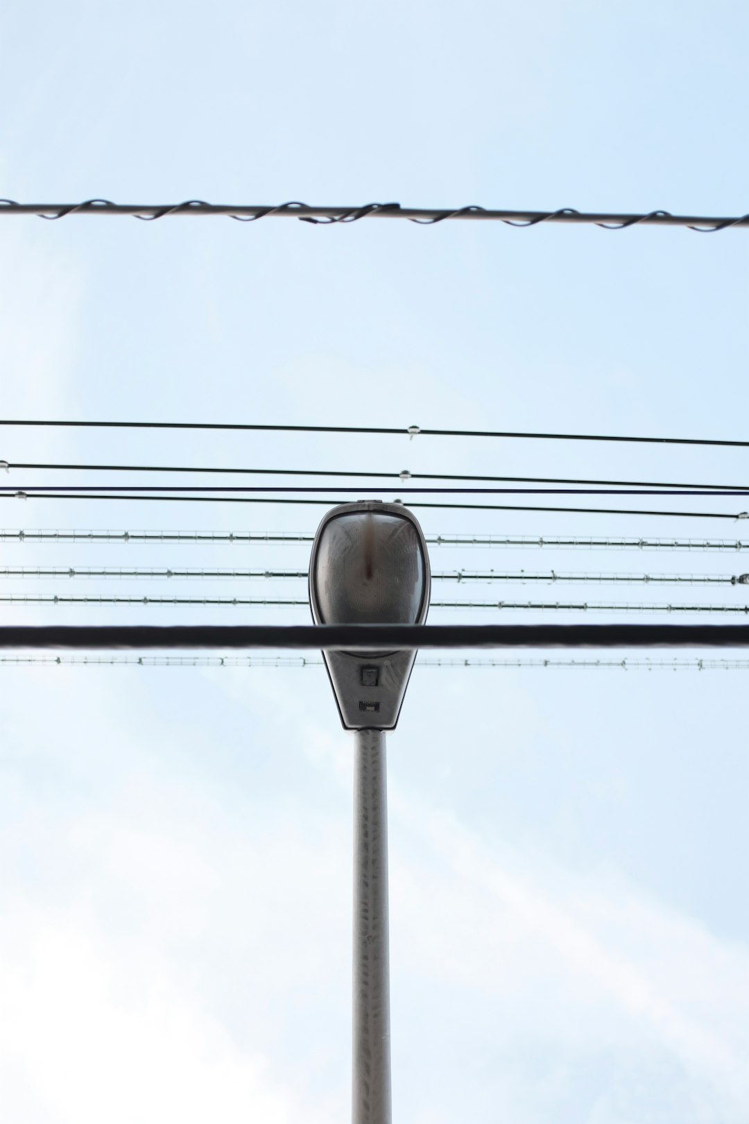 gray metal pole with cable wires during daytiem