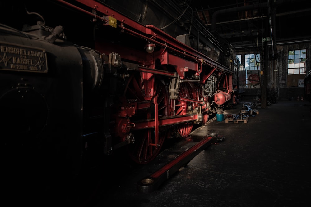 red and black train inside warehouse