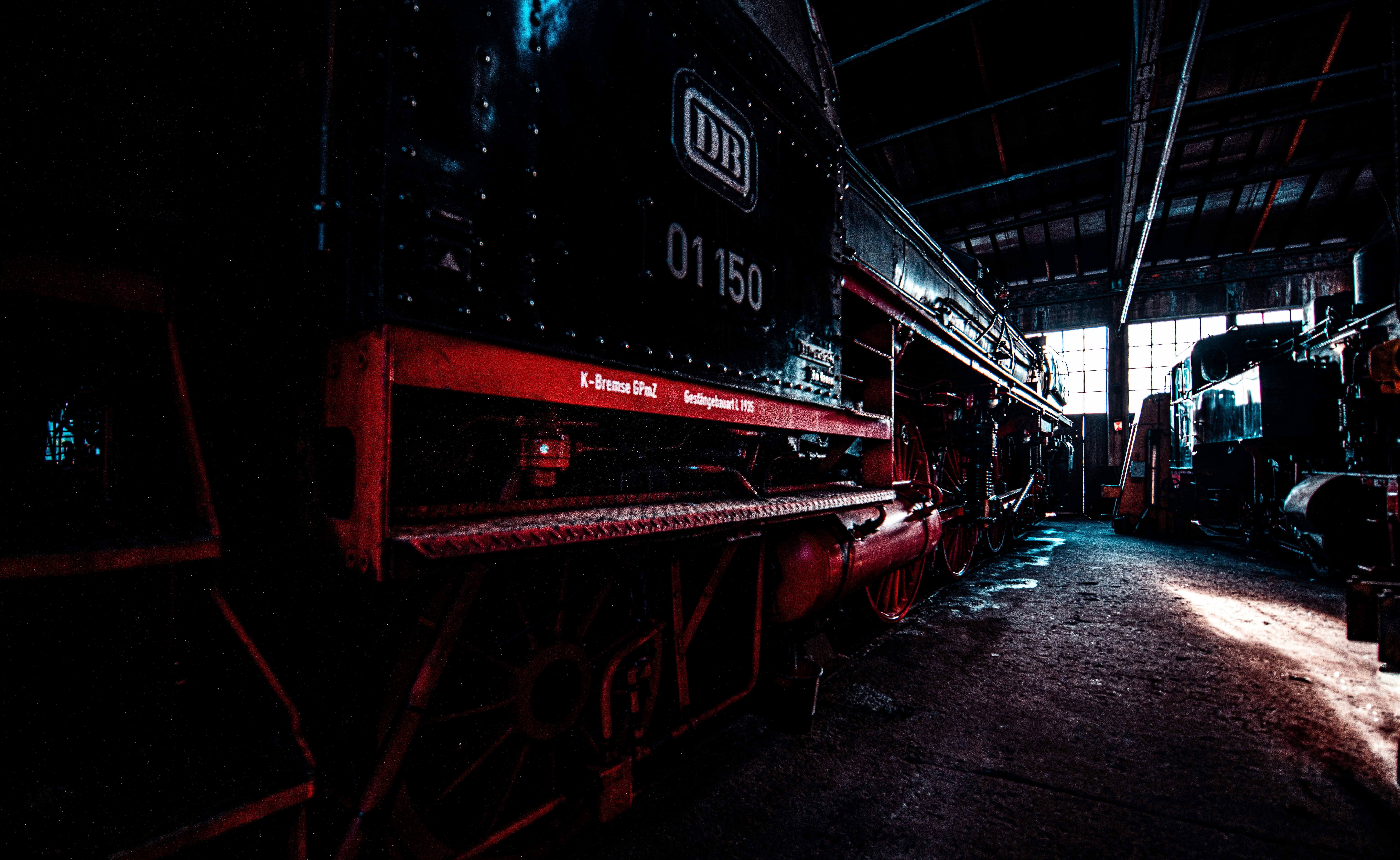 a train sitting in a train station next to another train