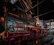 A vintage steam engine in a rustic workshop, softly lit to highlight its intricate metalwork.