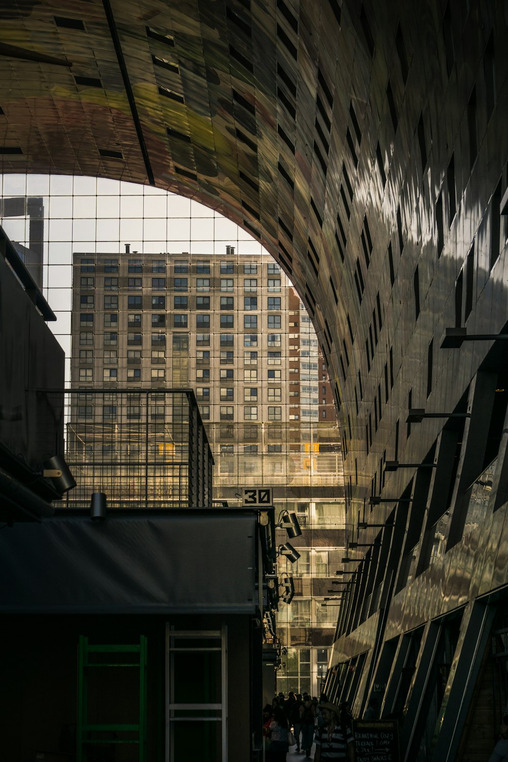 a very large building with some very tall buildings in the background