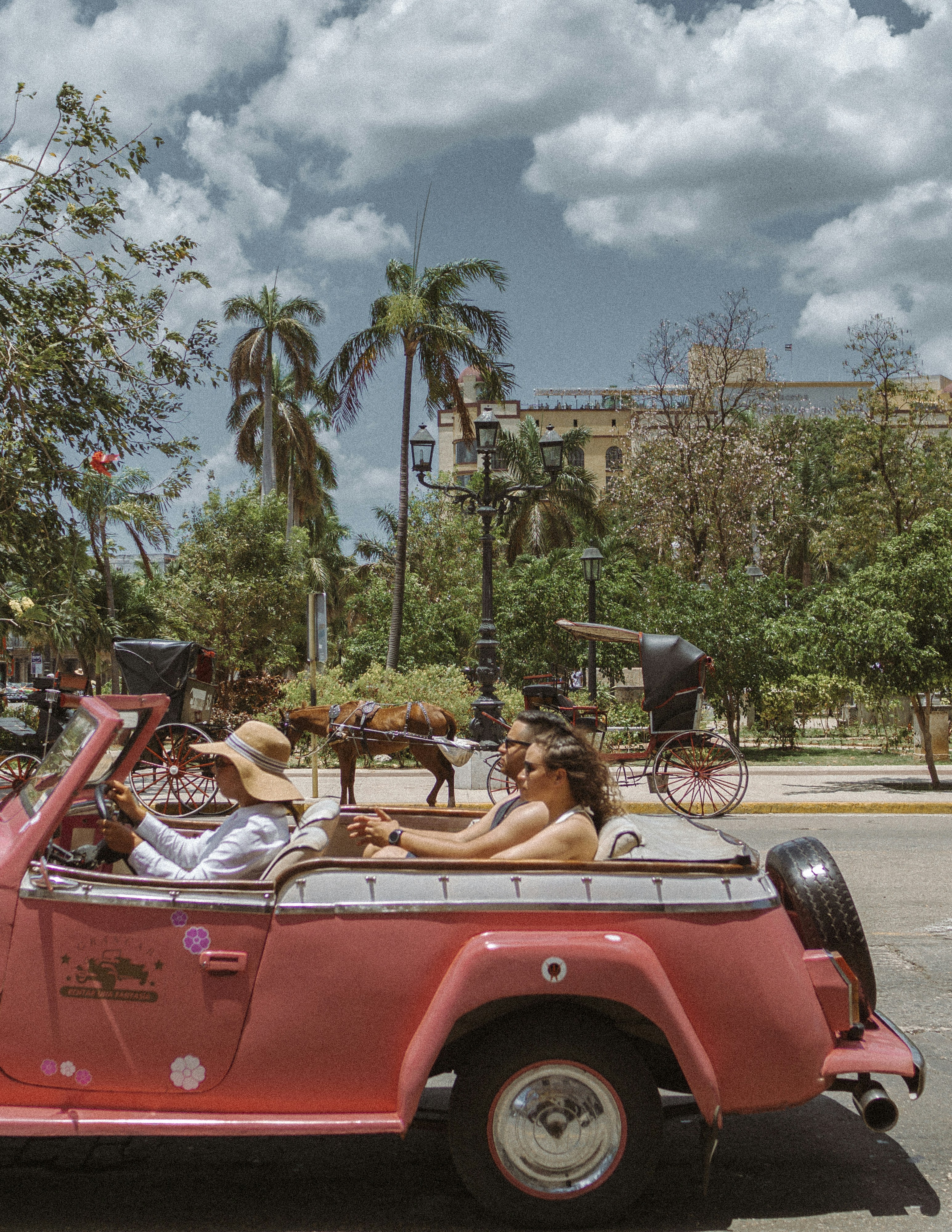 man and woman riding on vehicle