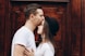 man kissing woman forehead