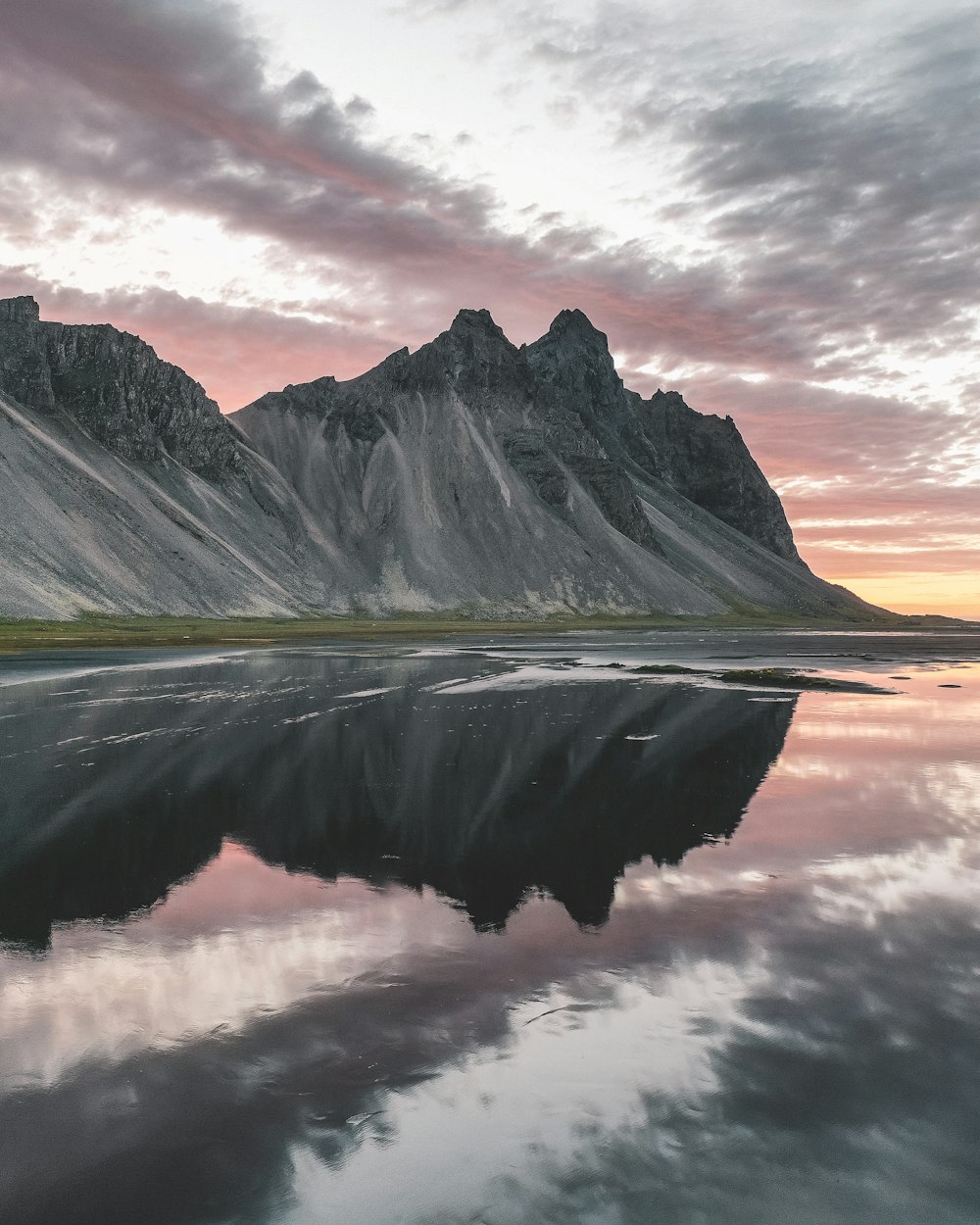 gray mountain and body of water