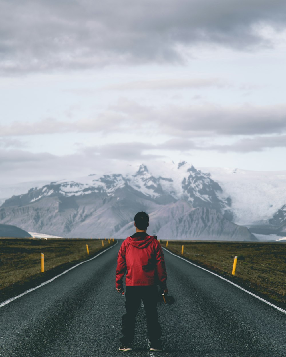 man standing on road