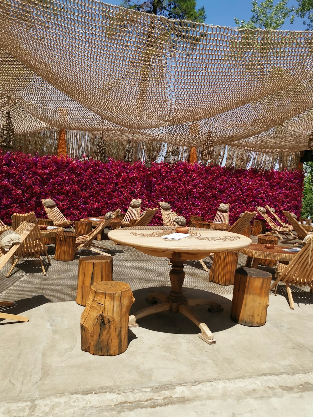 empty wooden chairs and tables outside during daytime