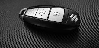 gray and black Suzuki car fob on black surface